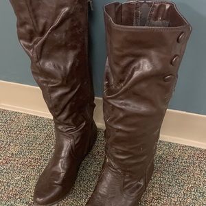 Knee high brown boots with brown buttons